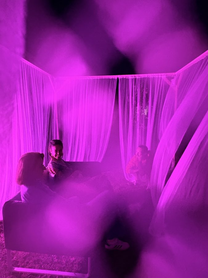 Visitors sitting inside the Solfeggio Tent at night, MAMA's House, Belezna